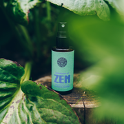 a bottle of 7 Flower Essence of Zen on top of tree stump